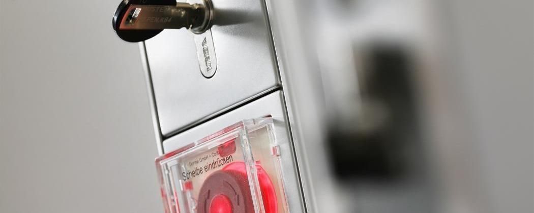 Roter Nottaster an einer Fluchttürsteuerung